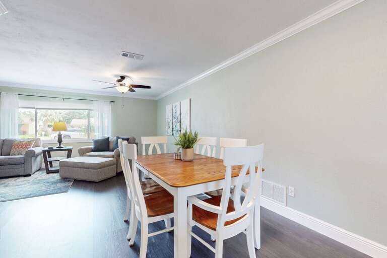 Bright Room With Dining Table Leading To Living Area