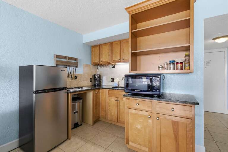Enjoy the convenience of a fully equipped kitchenette during your beach stay. Featuring a mini