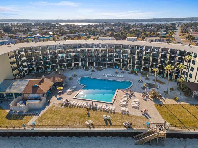 Experience the perfect beach stay at this oceanfront resort featuring a large pool, spacious sun deck, and direct beach access. Ideal for relaxing coastal vacations with beautiful waterfront views.