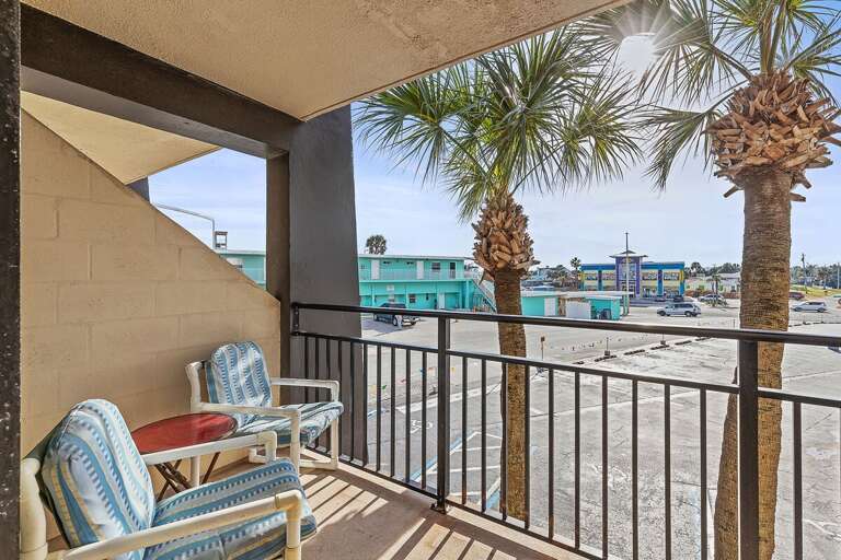 Relax on your private balcony with cozy seating and sunny palm views. The perfect beach stay retreat for morning coffee or evening unwinding, just steps from the sand and coastal attractions.