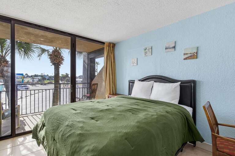 Wake up to palm views in this bright beach stay studio featuring a plush queen bed and private