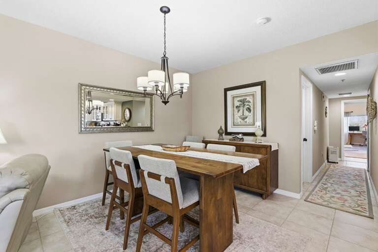 Charming dining space with elegant table seating and warm coastal décor. Ideal for shared meals and memorable moments during your beach stay, just steps from the kitchen and relaxing living areas.