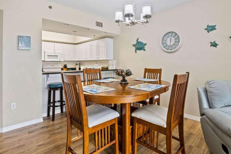 Gather for meals during your beach stay in this inviting coastal dining area with seating for four and easy access to the fully equipped kitchen. A perfect space to plan your next day of sun and sand.
