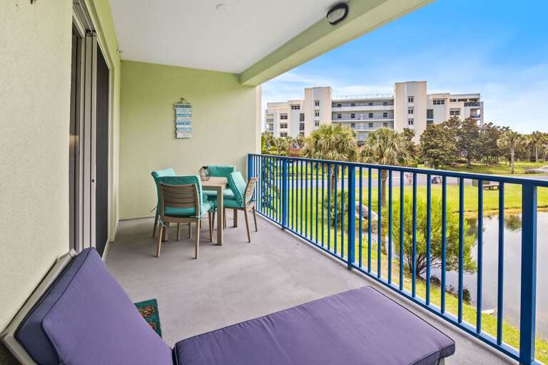 Soak in the sunshine during your beach stay on this private balcony featuring comfortable seating