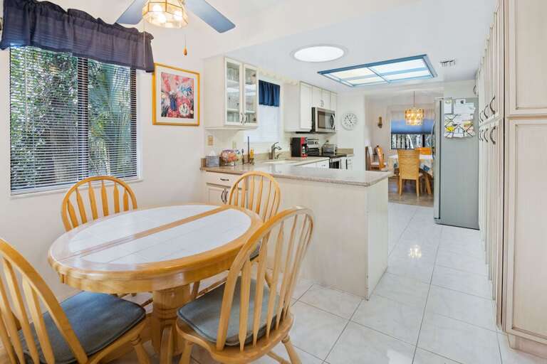Bright dining area and open kitchen with ample counter space and stainless appliances. Perfect for