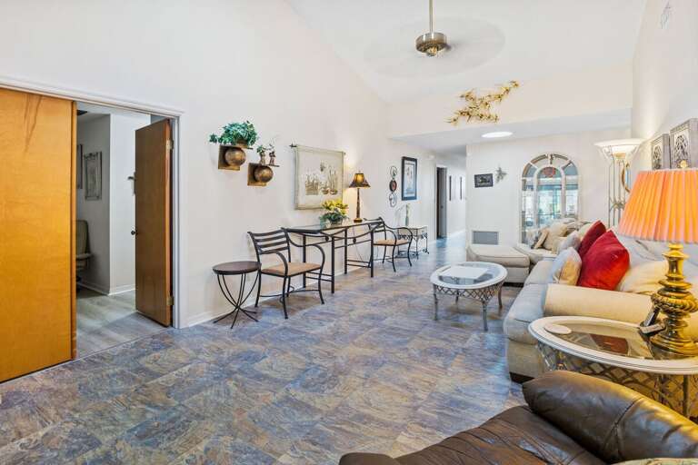 Spacious, open living area with cozy seating, vaulted ceilings, and coastal décor. Perfect for