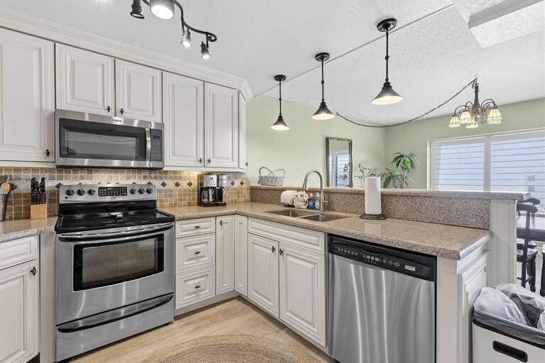 Enjoy a stylish coastal kitchen featuring stainless steel appliances, spacious countertops, and an