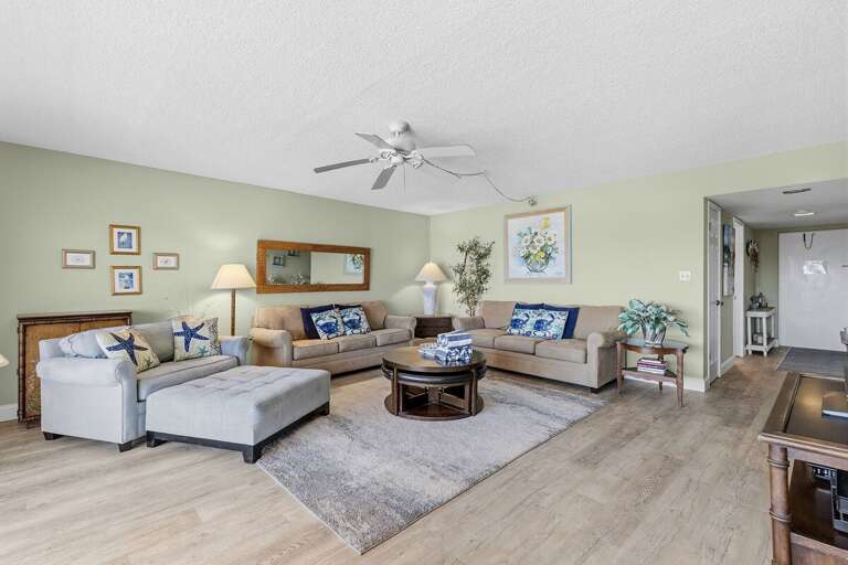 Gather and unwind in this bright coastal living space featuring plush seating, beach-inspired
