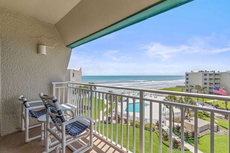 Soak in panoramic oceanfront views from your private balcony overlooking the beach and resort pool.