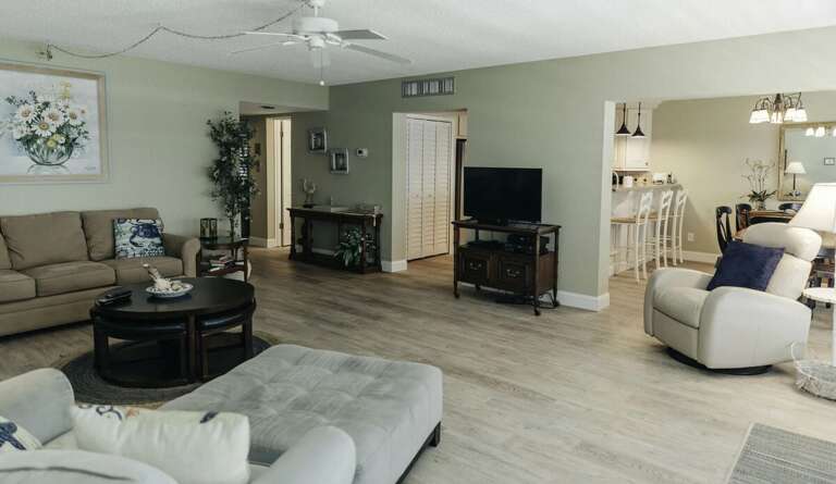 This spacious beach stay features an open-concept living and dining area with comfortable seating,