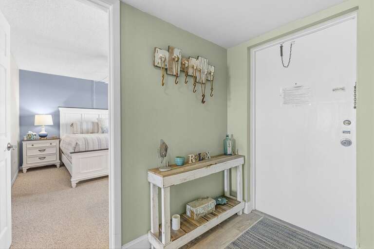 Step into comfort with this charming coastal entryway featuring beach-inspired décor and a relaxing atmosphere. Perfect for a stress-free beach stay just moments from the ocean and resort amenities.
