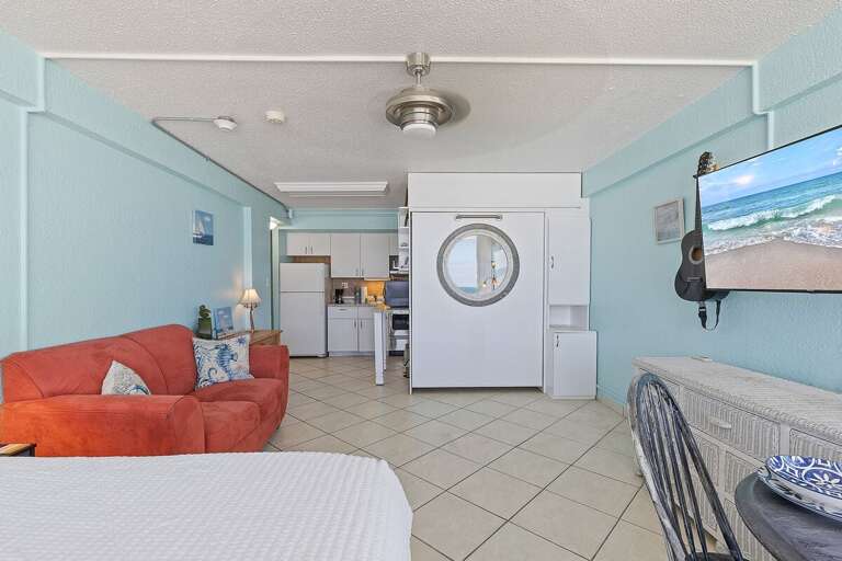 This inviting beach stay features a smart open layout with cozy seating, a full kitchen, and a space-saving Murphy bed. Enjoy comfort and convenience in a bright coastal setting near the ocean.