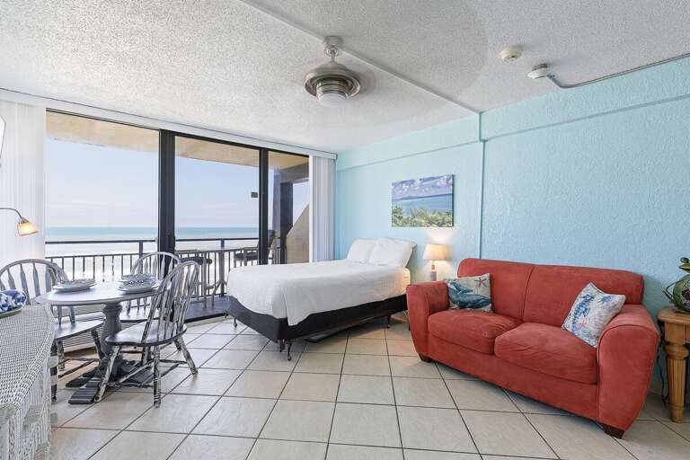 Wake up to ocean views in this bright beach stay studio featuring a cozy bed, coastal décor, and direct access to a private balcony. Enjoy indoor-outdoor living just steps from the sand and surf.
