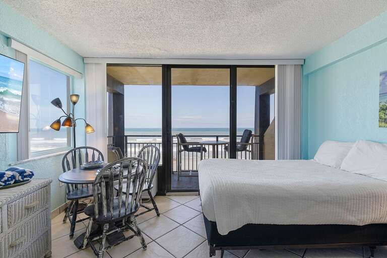 Wake up to ocean views in this beach stay featuring a cozy bed, dining space, and private balcony. Enjoy meals with a view and relax just steps from the sand and soothing coastal breeze.