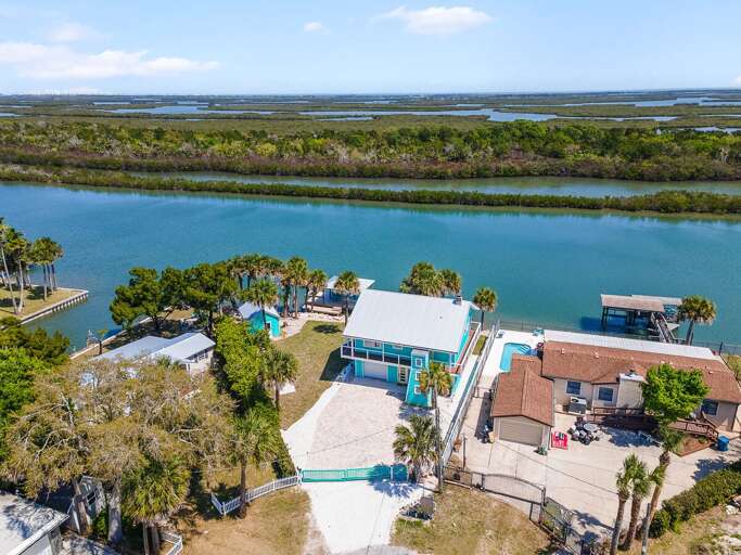 Take in breathtaking aerial views of this waterfront beach stay featuring a private dock, palm-lined