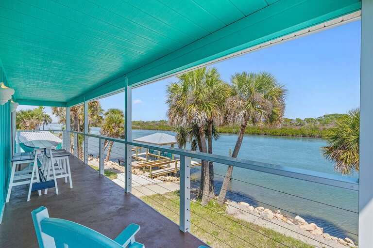Enjoy your beach stay from this spacious waterfront balcony with palm-lined views and outdoor