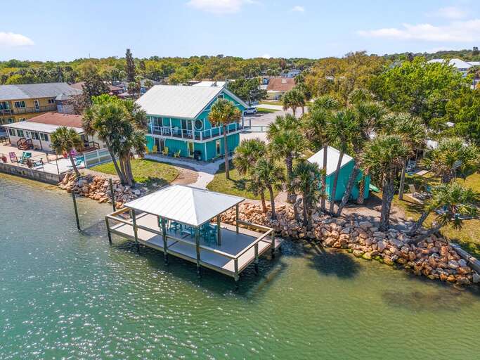 Enjoy a relaxing beach stay at this stunning waterfront home featuring a private covered dock,