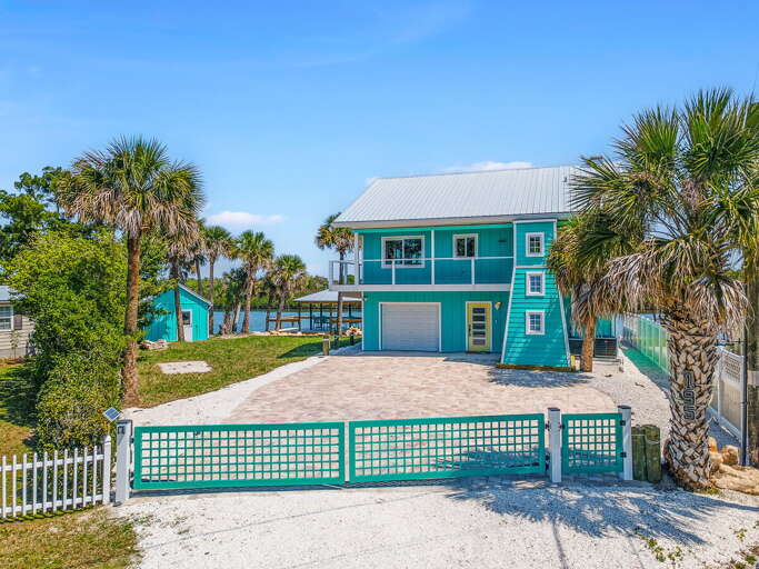 Experience the ultimate beach stay at this vibrant waterfront home featuring a private dock,
