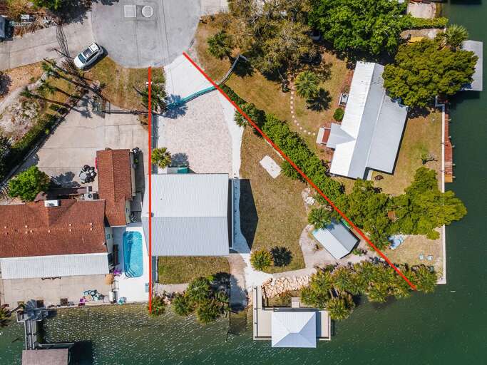 Plan your perfect beach stay at this waterfront property featuring a private dock, large lot, and