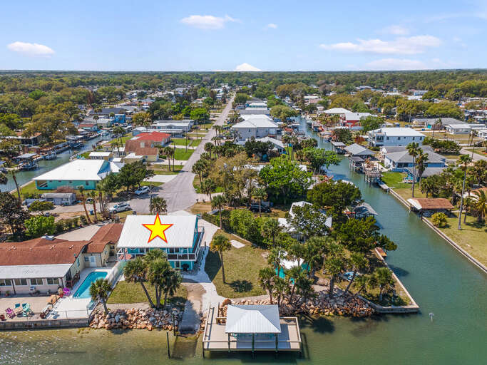 Relax on your perfect beach stay at this canal-front home featuring a private dock, serene water