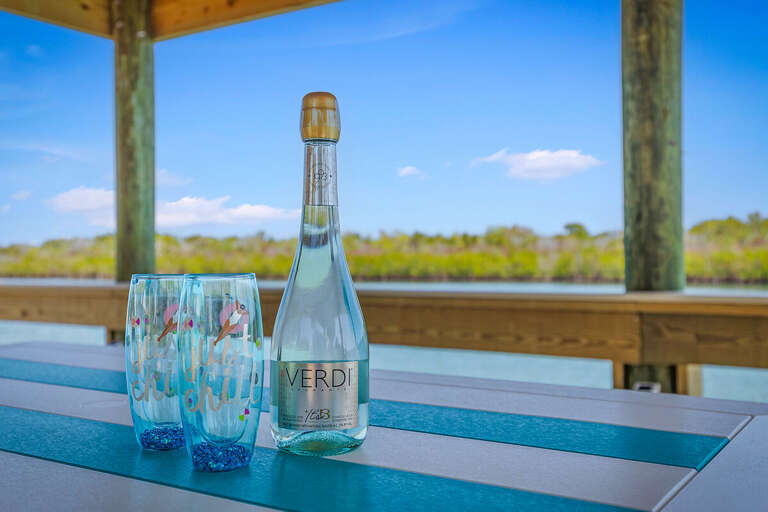 Toast to your perfect beach stay with drinks on the waterfront dock. Enjoy serene views, coastal breezes, and relaxing moments in a peaceful seaside setting made for unwinding.