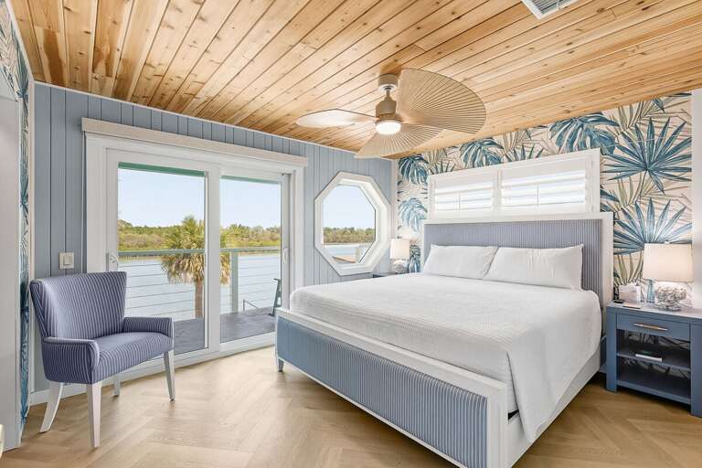 Unwind in this tranquil coastal bedroom featuring a king bed, tropical décor, and private balcony