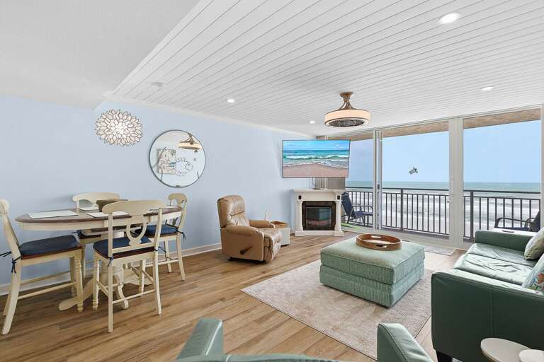 Enjoy this open-concept beach stay with oceanfront views, cozy seating, and a dining area perfect for gathering. Step onto the private balcony and take in the sights and sounds of the sea.