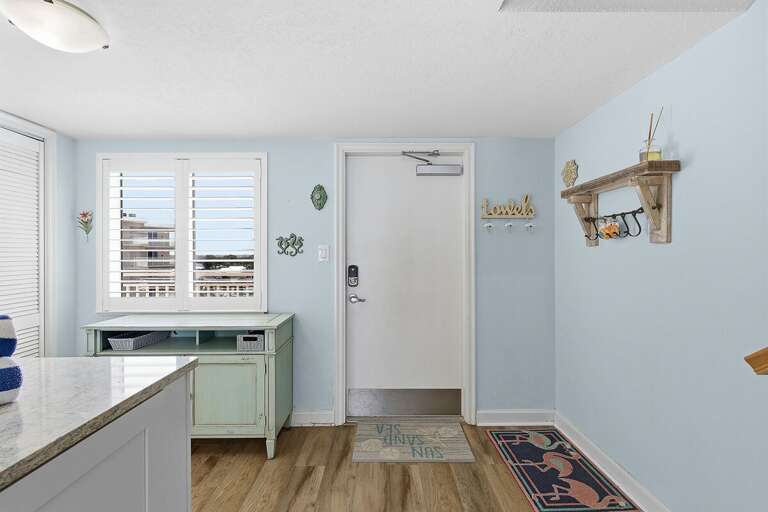 Start your beach stay with this bright, welcoming entryway featuring coastal décor and convenient storage. A perfect first impression that sets the tone for your relaxing seaside getaway.