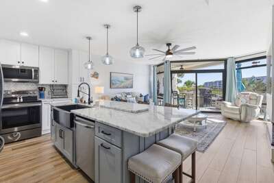 Enjoy a relaxing beach stay in this airy coastal condo featuring a modern kitchen, open living