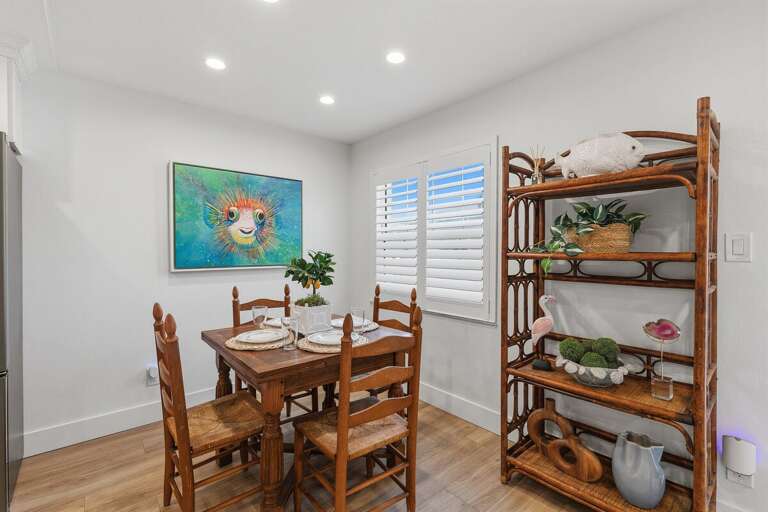 Share meals and memories in this cozy beach stay dining space featuring coastal décor, natural textures, and a bright inviting atmosphere perfect for relaxing after a day by the beach.