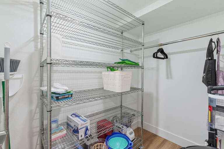 Stay organized during your beach stay with this spacious storage area featuring shelving, hanging space, and room for beach gear, luggage, and vacation essentials.