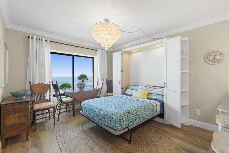 Maximize comfort and space in this stylish beach stay featuring a cozy Murphy bed, ocean views, coastal décor, and a bright dining area—perfect for relaxing seaside vacations and family getaways.