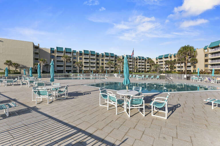 Relax poolside at this oceanfront resort featuring spacious sun decks, lounge seating, and coastal