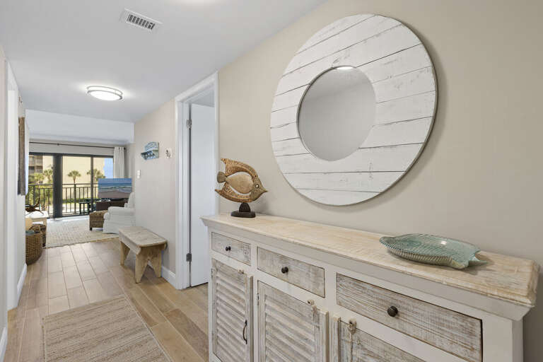 Step into your relaxing beach stay with this bright coastal-inspired condo entryway featuring