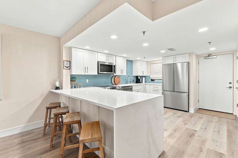 Cook and gather in this beautifully updated coastal kitchen featuring quartz countertops, stainless