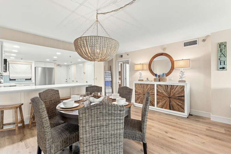 Enjoy meals in this stylish coastal dining area with comfortable seating, elegant beach-inspired
