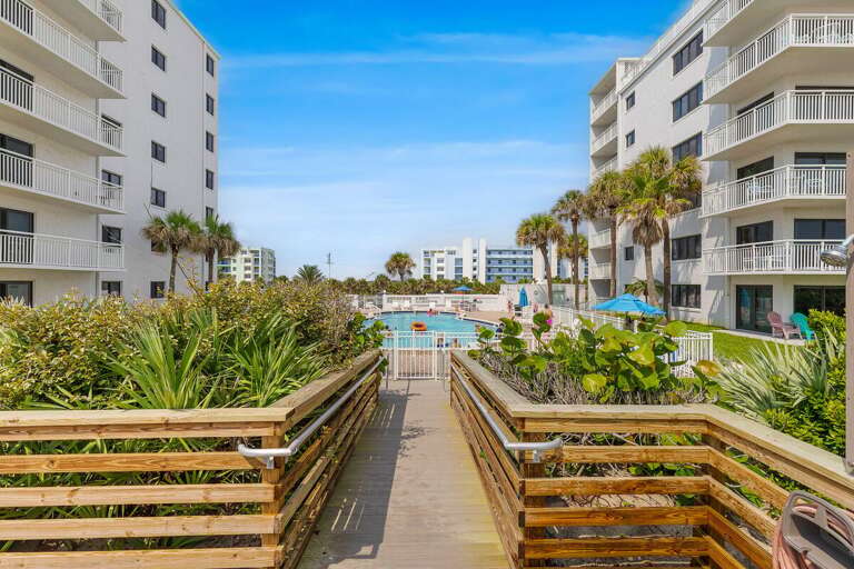 Follow the private boardwalk through lush tropical landscaping to the resort pool and direct beach
