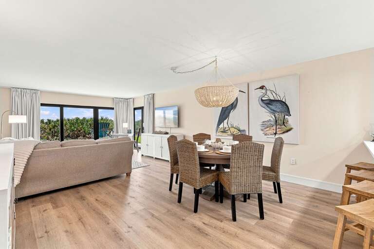 Gather in this spacious open-concept living and dining area featuring coastal décor, comfortable