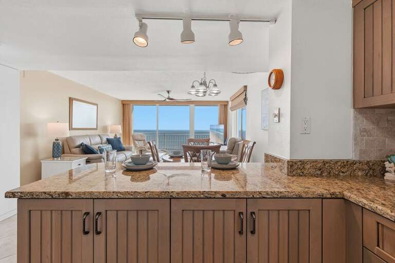 Enjoy an open kitchen overlooking the oceanfront living and dining area, with granite countertops