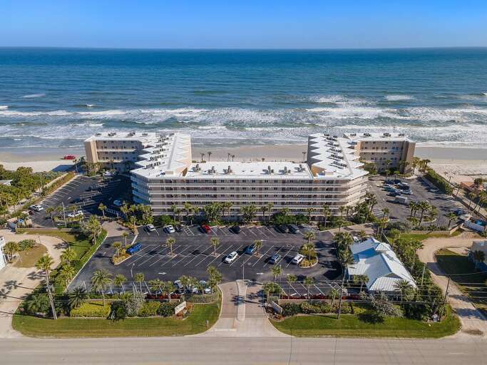 Take in the full oceanfront setting of The Pelican, ideally positioned along the sandy shoreline with the Atlantic just steps away—a convenient coastal retreat for a memorable New Smyrna Beach stay.