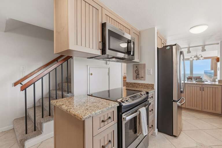 Prepare meals with ease in this well-equipped kitchen featuring granite countertops, stainless steel