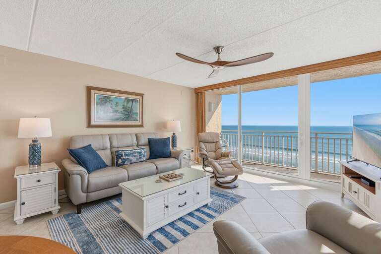 Settle into this inviting oceanfront living room with comfortable seating, coastal décor, and