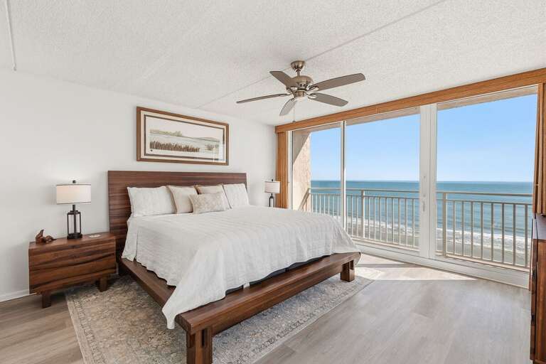 Wake up to breathtaking Atlantic Ocean views from this bright oceanfront bedroom, featuring a comfortable bed and direct balcony access for a peaceful start to every day of your beach stay.