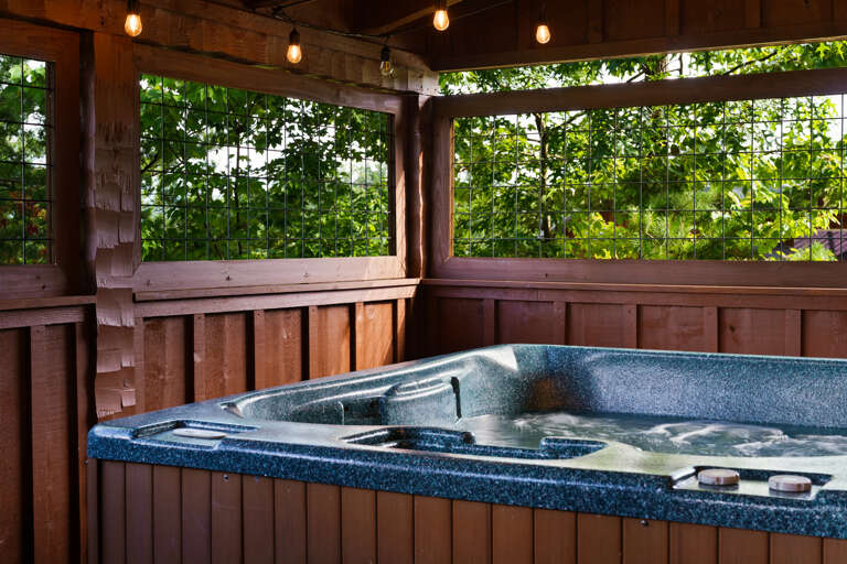 Soak away the day in your own private hot tub, tucked beneath a covered porch surrounded by the Smoky Mountains.