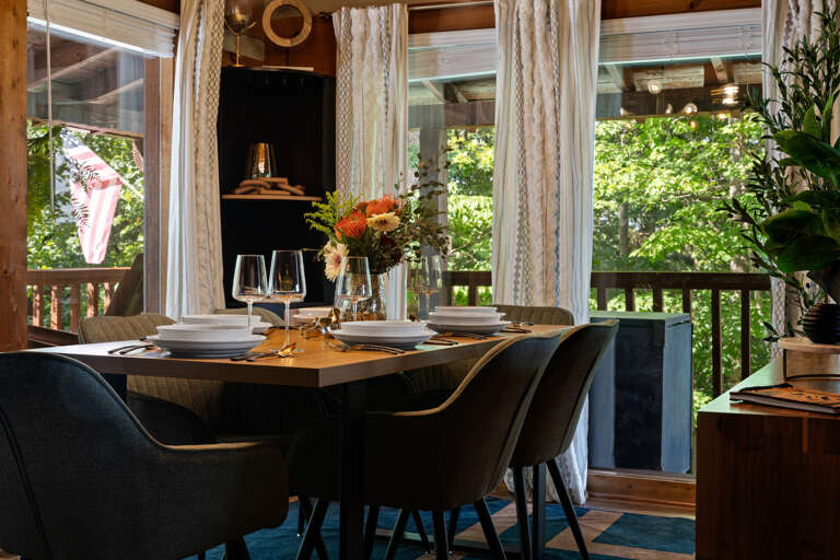 Gather around the dining table with a forest view just outside the window — a warm spot for shared meals at Dancing Embers.