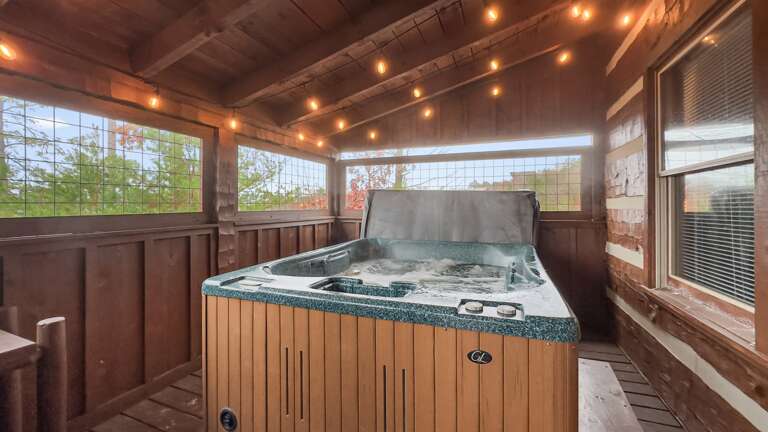 Soak under the warm glow of string lights while the crisp mountain air drifts around you—your private hot tub oasis awaits.