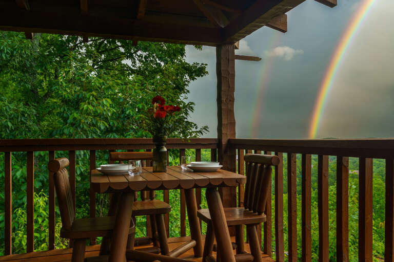 Catch a rainbow with your morning coffee — the deck dining table at Dancing Embers serves up unforgettable mountain views.