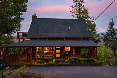 As dusk settles over the Smokies, Dancing Embers glows from every window — a sleek mountain retreat with modern style, ready to welcome you home.