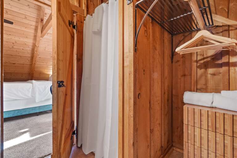 Modern charm meets everyday comfort — an upstairs bathroom with thoughtful cabin details and warm wood finishes.