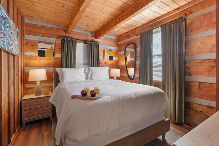 Rest easy in modern comfort — soft linens, warm lighting, and cozy cabin charm await after a day in the Smokies.